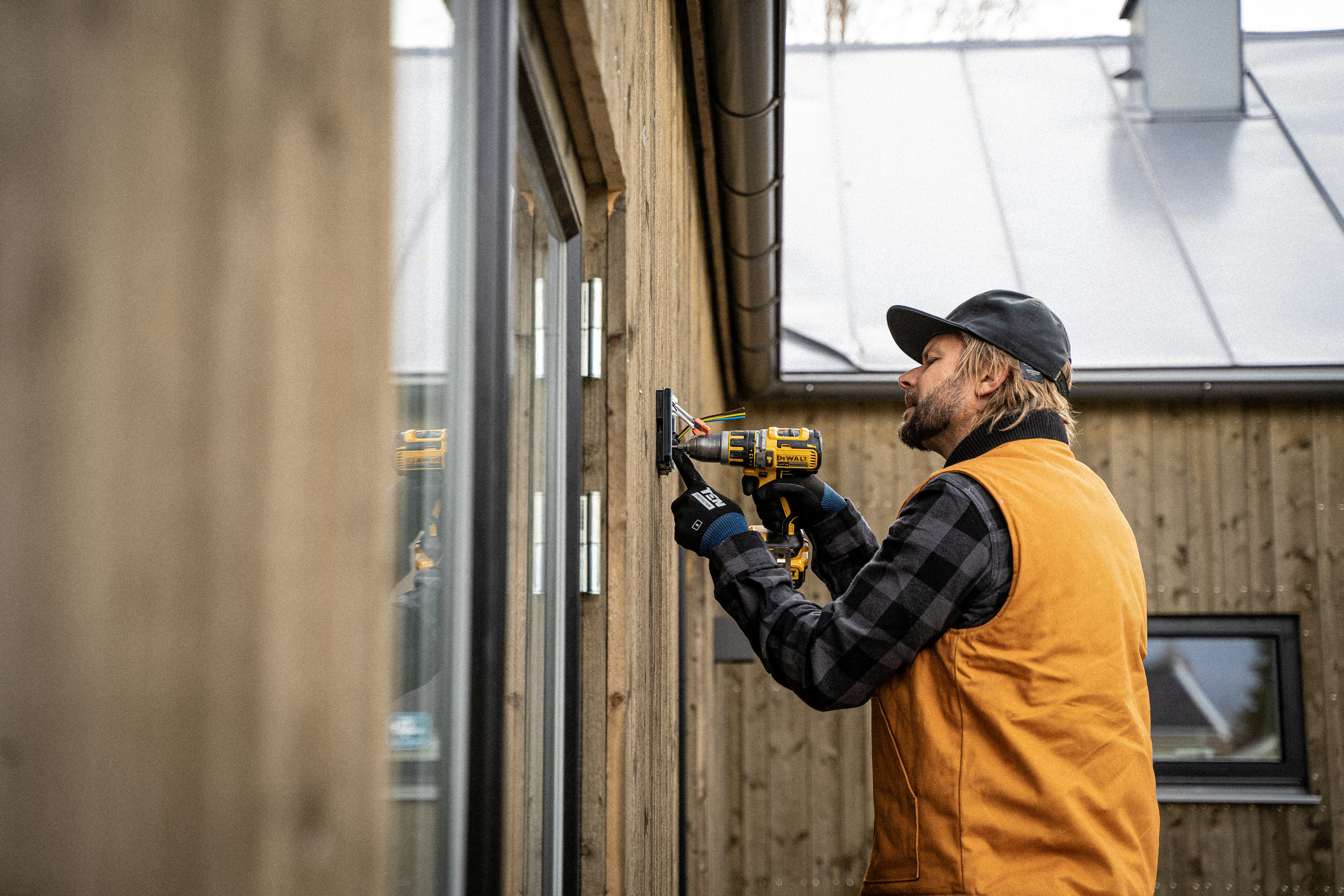 Building inspector working on a home exterior showing professional property inspection and hidden repair cost assessment